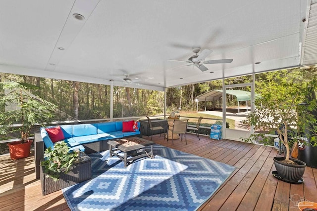 deck featuring outdoor dining area, a ceiling fan, and an outdoor hangout area