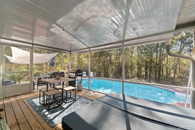 outdoor pool with outdoor dining space and area for grilling