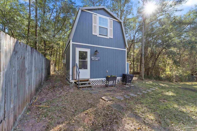 view of outbuilding featuring a fenced backyard and entry steps