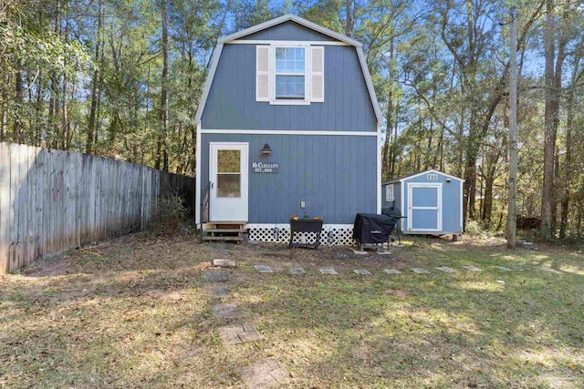 view of shed with entry steps and fence