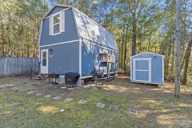 view of shed with entry steps and fence