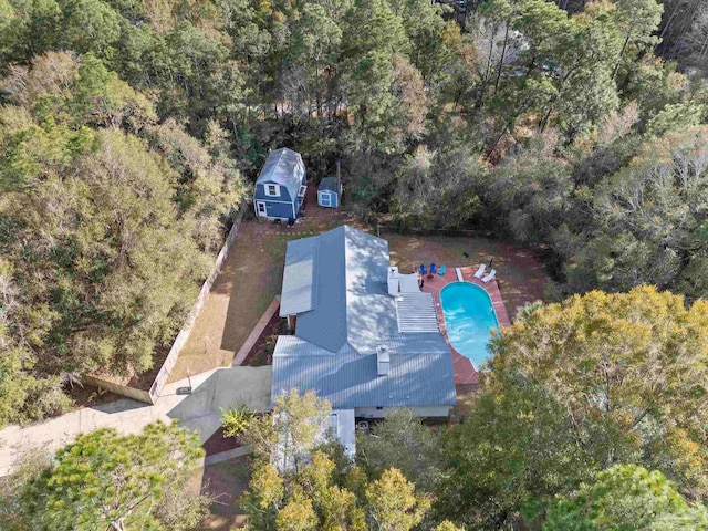 drone / aerial view featuring a wooded view