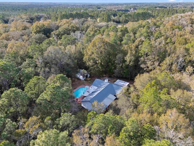 drone / aerial view with a wooded view