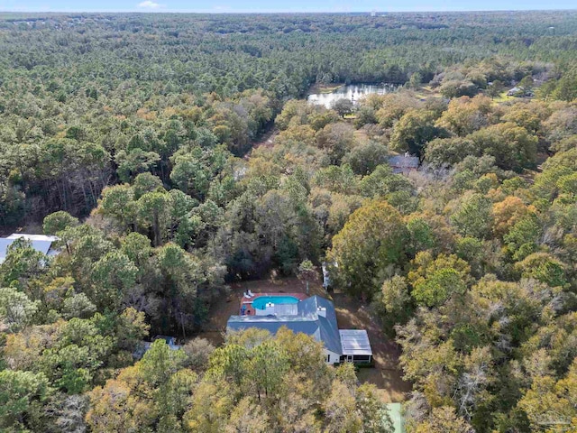 birds eye view of property featuring a wooded view