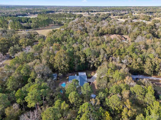 birds eye view of property featuring a wooded view