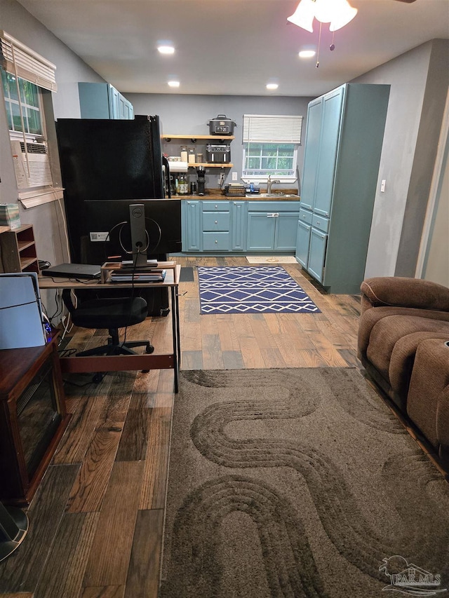 office space with light wood finished floors, recessed lighting, ceiling fan, and a sink