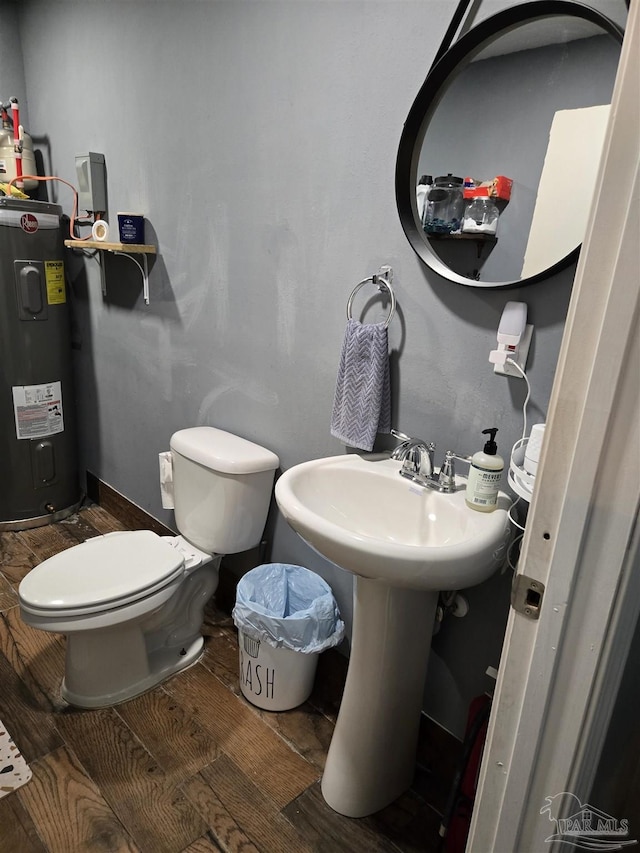 bathroom featuring toilet, wood finished floors, and water heater