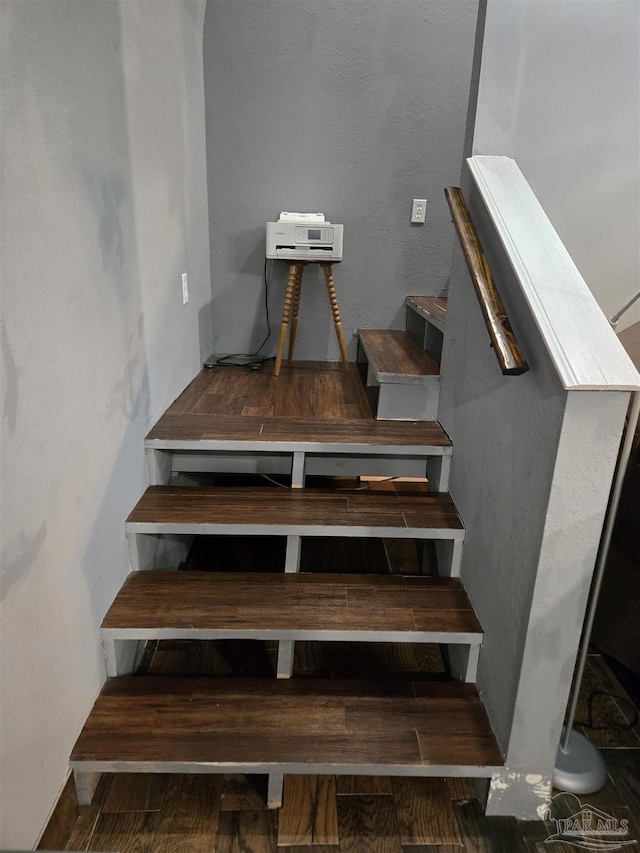 stairs featuring wood finished floors