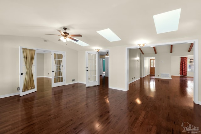 spare room featuring french doors, dark hardwood / wood-style flooring, lofted ceiling with skylight, and ceiling fan