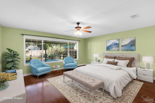 bedroom featuring ceiling fan, dark hardwood / wood-style floors, and multiple windows