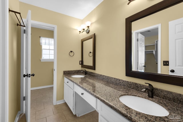 bathroom featuring tile patterned flooring and vanity