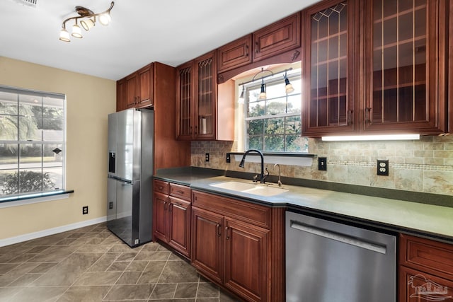 kitchen featuring backsplash, stainless steel appliances, plenty of natural light, and sink