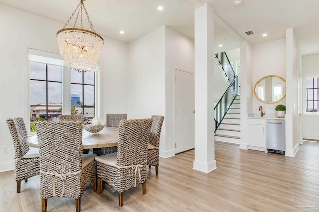 dining area with recessed lighting, light wood-type flooring, visible vents, and stairway