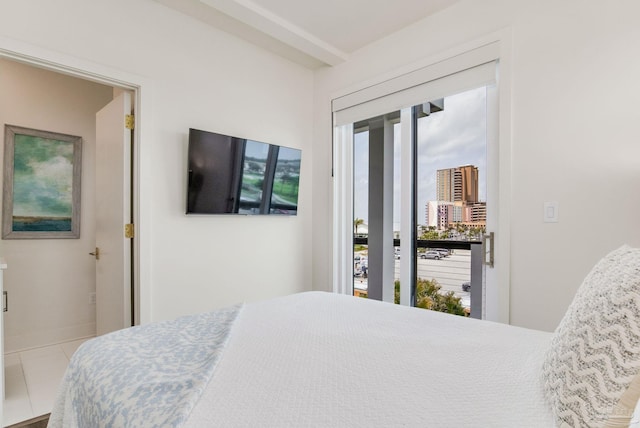 bedroom featuring tile patterned flooring and baseboards