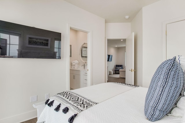 bedroom with a sink and ensuite bath