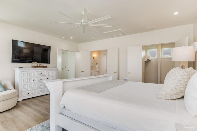 bedroom with a ceiling fan, wood finished floors, recessed lighting, connected bathroom, and attic access