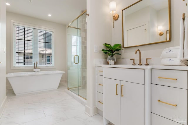 full bathroom featuring a soaking tub, marble finish floor, a stall shower, and vanity