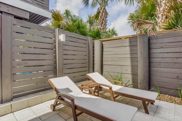 view of patio featuring fence