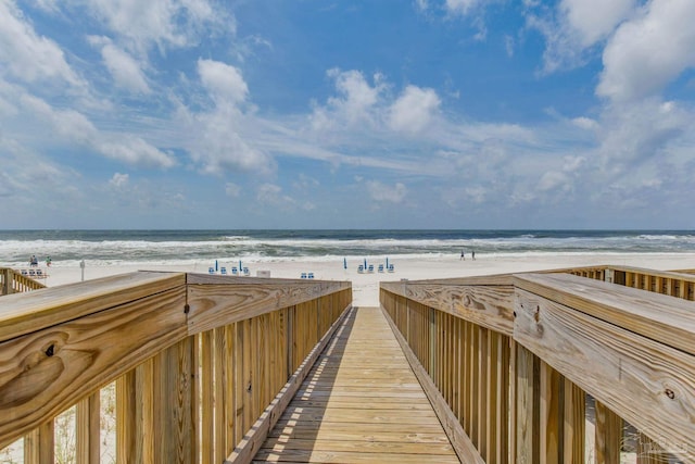 surrounding community with a water view and a view of the beach