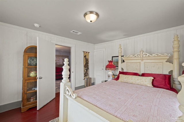 bedroom with visible vents and wood finished floors