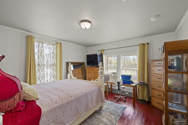 bedroom with hardwood / wood-style flooring, multiple windows, and crown molding