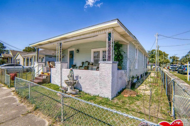 view of front of house with a fenced front yard and a porch