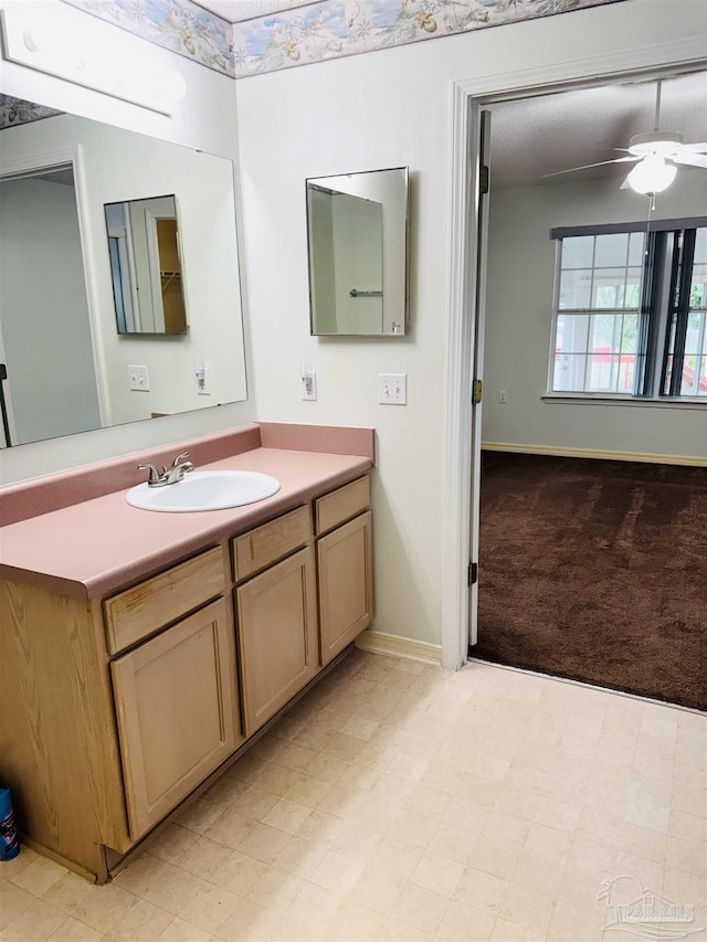 3081 Flintlock Dr, Pensacola, FL 32526 - bathroom featuring vanity, baseboards, and ceiling fan