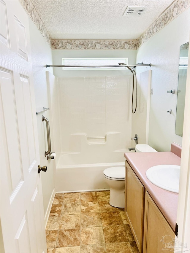 3081 Flintlock Dr, Pensacola, FL 32526 - bathroom featuring toilet, vanity, bathing tub / shower combination, and a textured ceiling