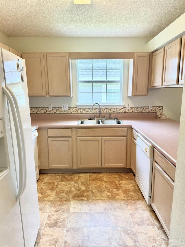 3081 Flintlock Dr, Pensacola, FL 32526 - kitchen featuring a sink, white appliances, light countertops, a textured ceiling, and stone finish floors