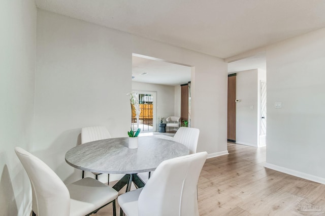 dining area with light hardwood / wood-style floors