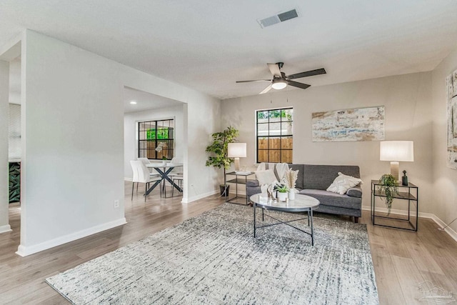 living room featuring wood-type flooring and ceiling fan