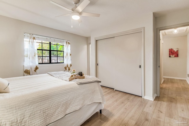 bedroom with a closet, ceiling fan, and light hardwood / wood-style flooring