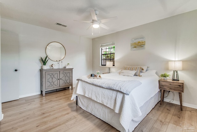 bedroom with light hardwood / wood-style floors and ceiling fan