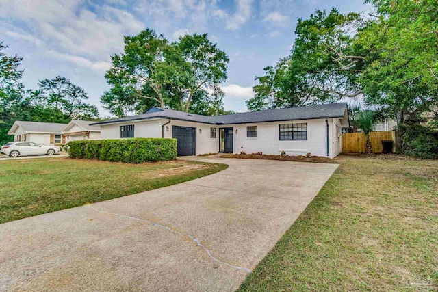 single story home with a front yard and a garage