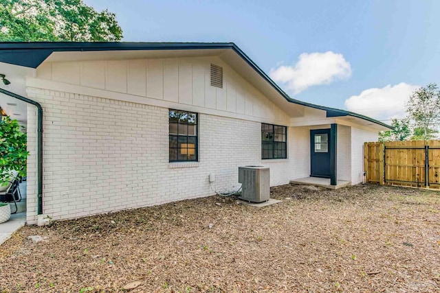 view of side of home featuring central AC