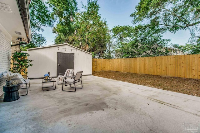 view of patio / terrace with an outdoor fire pit and a shed