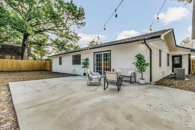 back of property featuring a patio and central AC