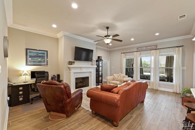 living room with ceiling fan, ornamental molding, and light hardwood / wood-style flooring