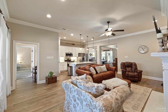 living room featuring crown molding, light wood-type flooring, and ceiling fan