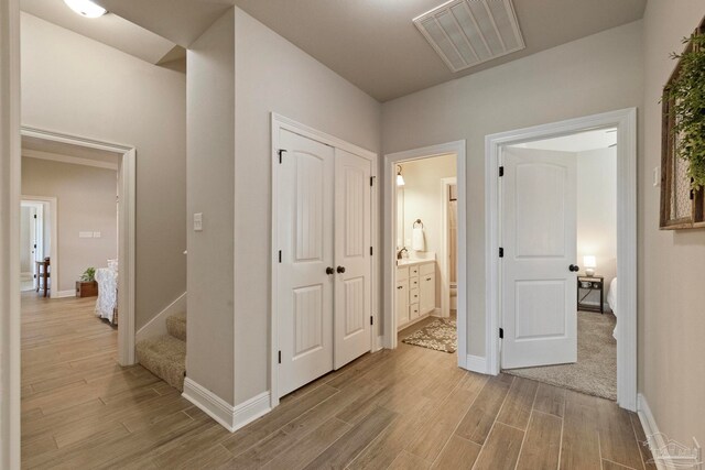 hallway with light hardwood / wood-style flooring