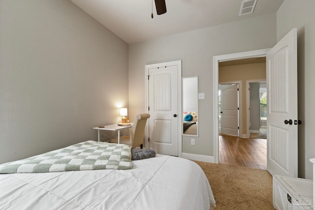 bedroom featuring light hardwood / wood-style flooring, a closet, vaulted ceiling, and ceiling fan