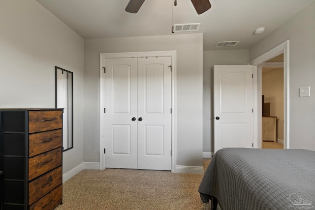 carpeted bedroom with a closet and ceiling fan