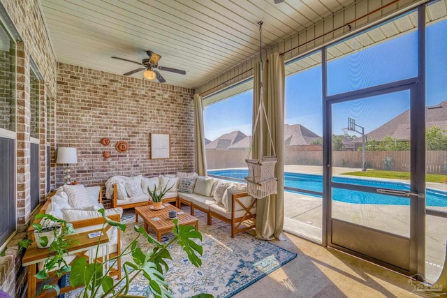 sunroom with wood ceiling and ceiling fan