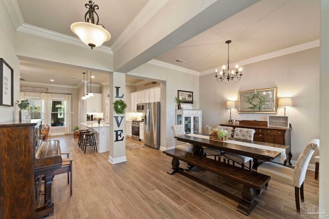 dining space featuring light hardwood / wood-style floors, ornamental molding, and a chandelier