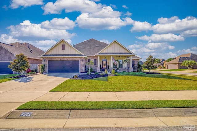 craftsman inspired home with a garage and a front lawn