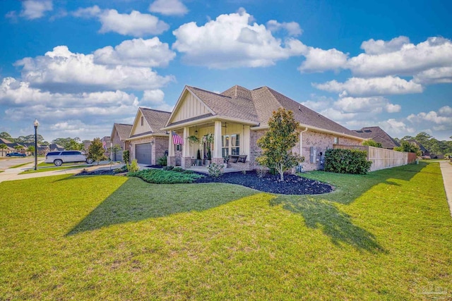 craftsman-style home with covered porch, a front yard, and a garage