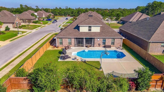 view of swimming pool with a patio area and a yard