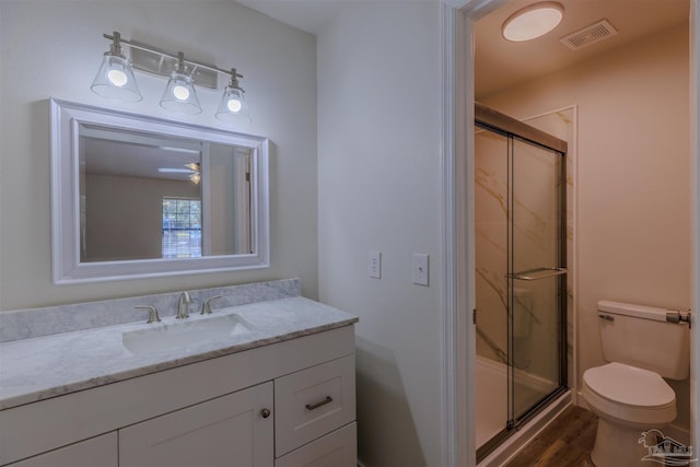 full bath featuring visible vents, a shower stall, toilet, wood finished floors, and vanity