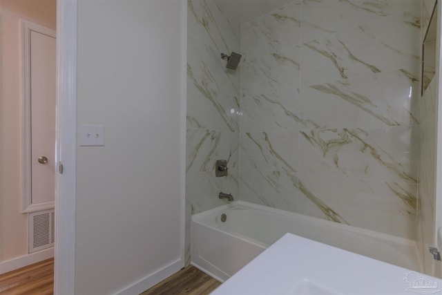 full bath featuring shower / bathing tub combination, visible vents, baseboards, and wood finished floors