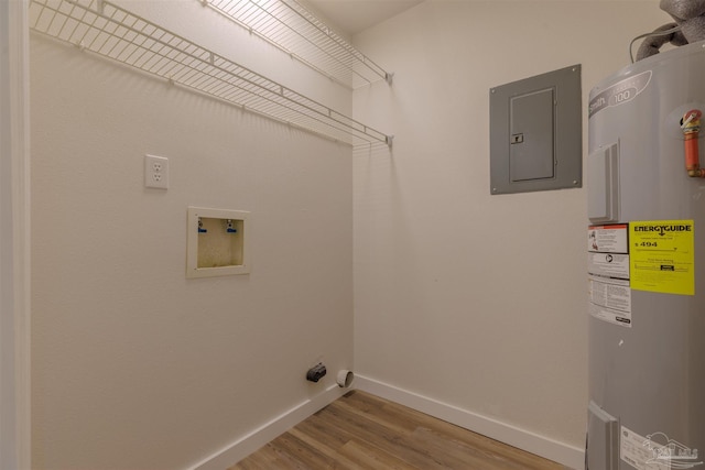 laundry area with wood finished floors, laundry area, electric panel, electric dryer hookup, and electric water heater